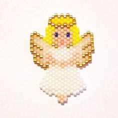 a beaded angel ornament on a white background