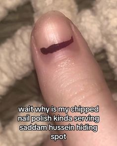 a finger with a black marker on it that says, wait why is my chipped nail polish kinda serving saddan hussen hiding spot?