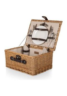 an open wicker picnic basket with utensils in it