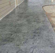 an empty driveway next to two garages