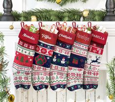 christmas stockings hanging from a mantel in front of a fireplace