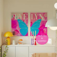 two paintings on the wall above a buffet table with candles and vases in front of it