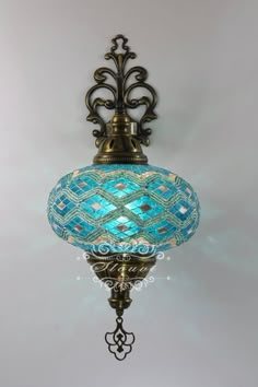 a blue glass light hanging from the ceiling