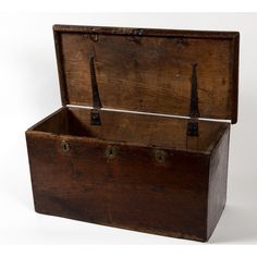 an old wooden box with two handles and straps