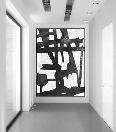 black and white abstract painting in an empty room