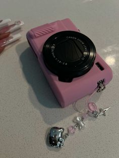 a pink camera sitting on top of a table