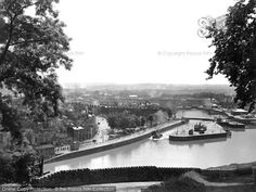 an old black and white photo of a river