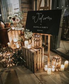 a welcome sign surrounded by candles and flowers