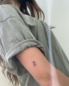 a woman with a small tattoo on her arm