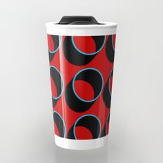 a red and black cup with blue circles on it