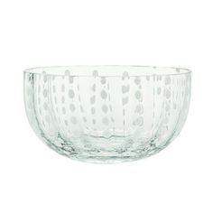 a glass bowl on a white background with polka dot design in the bottom and sides