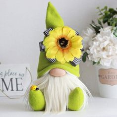 a green gnome with a yellow flower on his head