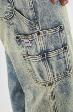 Travel back in time to the 2000s in nonstretch-denim carpenter jeans designed with full-length legs and plenty of pockets for utilitarian detail. Zip fly with button closure Front scoop pockets; coin patch pocket; back patch pockets; cargo patch pocket 100% cotton Machine wash, tumble dry Imported Vintage Cargo Jeans With Medium Wash And Pockets, Vintage Straight Leg Cargo Jeans With Hip Pockets, Rugged Faded Bottoms With Pockets, Vintage Denim Cargo Jeans, Vintage Cargo Jeans With Pockets In Medium Wash, Vintage Dark Wash Jeans With Cargo Pockets, Vintage Denim Cargo Jeans With Five Pockets, 90s Style Faded Bottoms With Pockets, Rugged Denim Blue Bottoms With Pockets