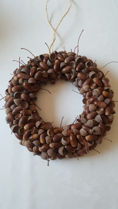 a wreath made out of acorns is hanging on the wall