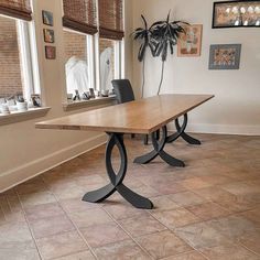 a wooden table sitting in the middle of a room