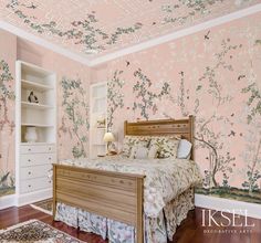 a bedroom with pink wallpaper and white furniture, including a bed in the center