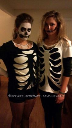 two women dressed in skeleton costumes posing for a photo with their faces painted white and black