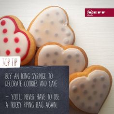 some heart shaped cookies are next to a sign that says, top tip buy an icing stinge to decorate cookies and cake you'll never have to use a tricky piping bag again