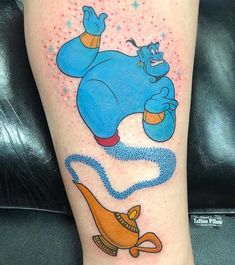 a cartoon character tattoo on the leg of a woman's leg, with an image of dumbo