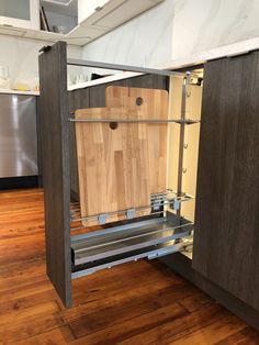 an open cabinet with cutting boards in it