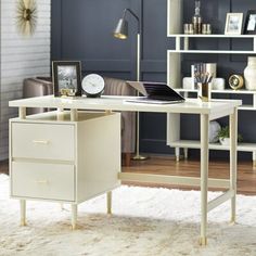 a pink desk with two drawers and a clock on the top shelf next to it