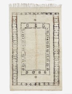 an old rug with fringes on the edges and a square design in the middle