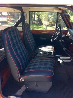 the interior of an old car with blue and black plaid upholstered seat covers