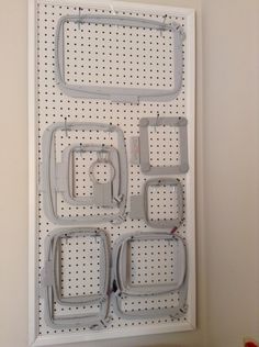 a white pegboard with several pieces of plastic on it