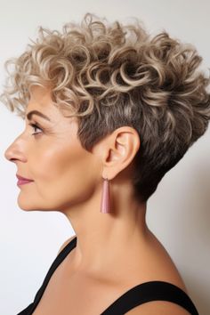 Go bold with a voluminous curly pixie cut. This hairstyle allows your curls to take center stage, providing texture and dimension. Click here to check out more vibrant hairstyles & haircuts for women over 50. Grey Curly Pixie Haircut, Very Short Permed Hair, Gray Curly Pixie Haircut, Short Pixie Curly Hairstyles, Short Stacked Hair Undercut, Permed Pixie Hairstyles, Short Curly Haircuts For Women Over 50, Pixie Hairstyles Curly Hair, Short Curly Pixie Haircuts