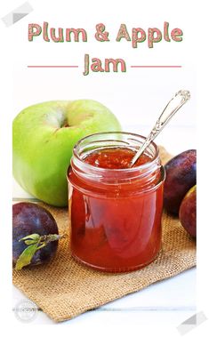 a jar of apple jam next to some apples on a cloth with a spoon in it