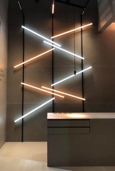 a counter with some lights on it in front of a wall that is lit up