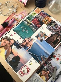 an open notebook with pictures and scissors on top of it next to other items that are sitting on a table