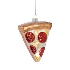 a slice of pizza ornament hanging from a string on a white background,