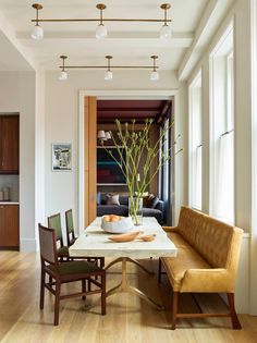 a dining room table with chairs and a bench