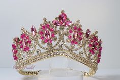 Beautiful Gold Crown with Hot Pink Stones Perfect for any occasion. Approx. 3" tall It has a loop at the end of each side to attach it in your hair with bobby pins for added security. Ships 1-2 business days. Pink And Gold Crown, Dream Quinceanera, Pink Tiara, Sweet 15 Party Ideas, Quinceanera Crown, Tiara Gold, Pink Quince, Pretty Quinceanera Dresses, Quince Dress