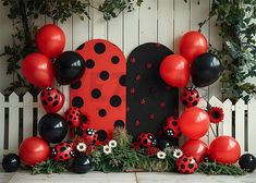 red and black balloons are arranged in the shape of a ladybug