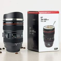 a camera lens sitting next to a box with coffee in it and its lid open