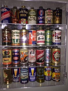 a shelf filled with lots of different types of beer cans on top of each other