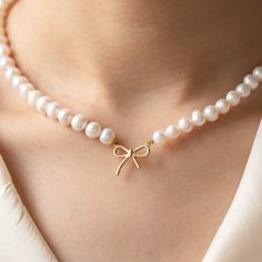 Bow Preal Necklace | Gold Bow Necklace | Handmade Pearl Jewelry | Minimalist Necklace for Women | Wedding Gift | Unique Christmas Gift for Her ✨The Bow Pearl Necklace is a beautiful and delicate handcrafted piece of jewelry that exudes elegance and charm.  The minimalist design adds a touch of sophistication, making it a versatile accessory for both casual and formal occasions.   Whether you're attending a wedding or simply going out for a lunch date, this necklace will effortlessly enhance your Elegant Wedding Necklace With Decorative Bow, Pearl Necklaces With Bow For Wedding, Dainty Adjustable Necklaces With Bow, Bow Pearl Necklace, Pearl Bow Necklace, Gold Necklaces With Bow Detail, Necklaces Pearl Bow, Handmade Pearl Jewelry, Gold Minimalist Jewelry