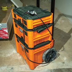 an orange and black cooler sitting on top of a floor