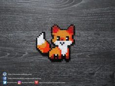 a pixelated fox is sitting on top of a wooden surface, with the background made up of wood planks