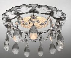 a chandelier with crystal drops hanging from the ceiling