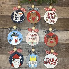 christmas ornaments are hanging on a wooden wall