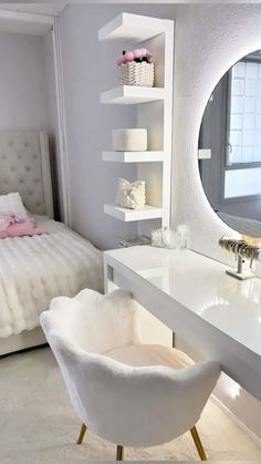 a bedroom with a white bed, mirror and chair in the corner next to it