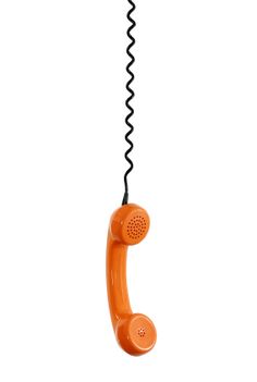 an orange telephone is hanging from a black cord on a white background with the phone in the air