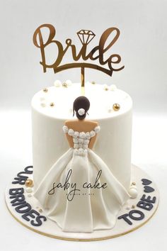 a wedding cake with a bride and groom topper sitting on it's side