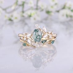 a ring with green and white stones on it