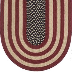 an oval rug with red and white stripes on the bottom, in front of a white background