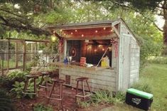 an outhouse is set up in the woods with lights on it's roof