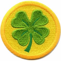 a green shamrock leaf on a yellow circle